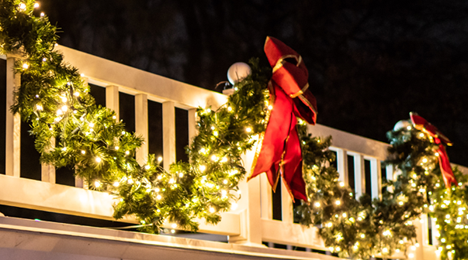 Garland With Red Bows Hanging from Railing